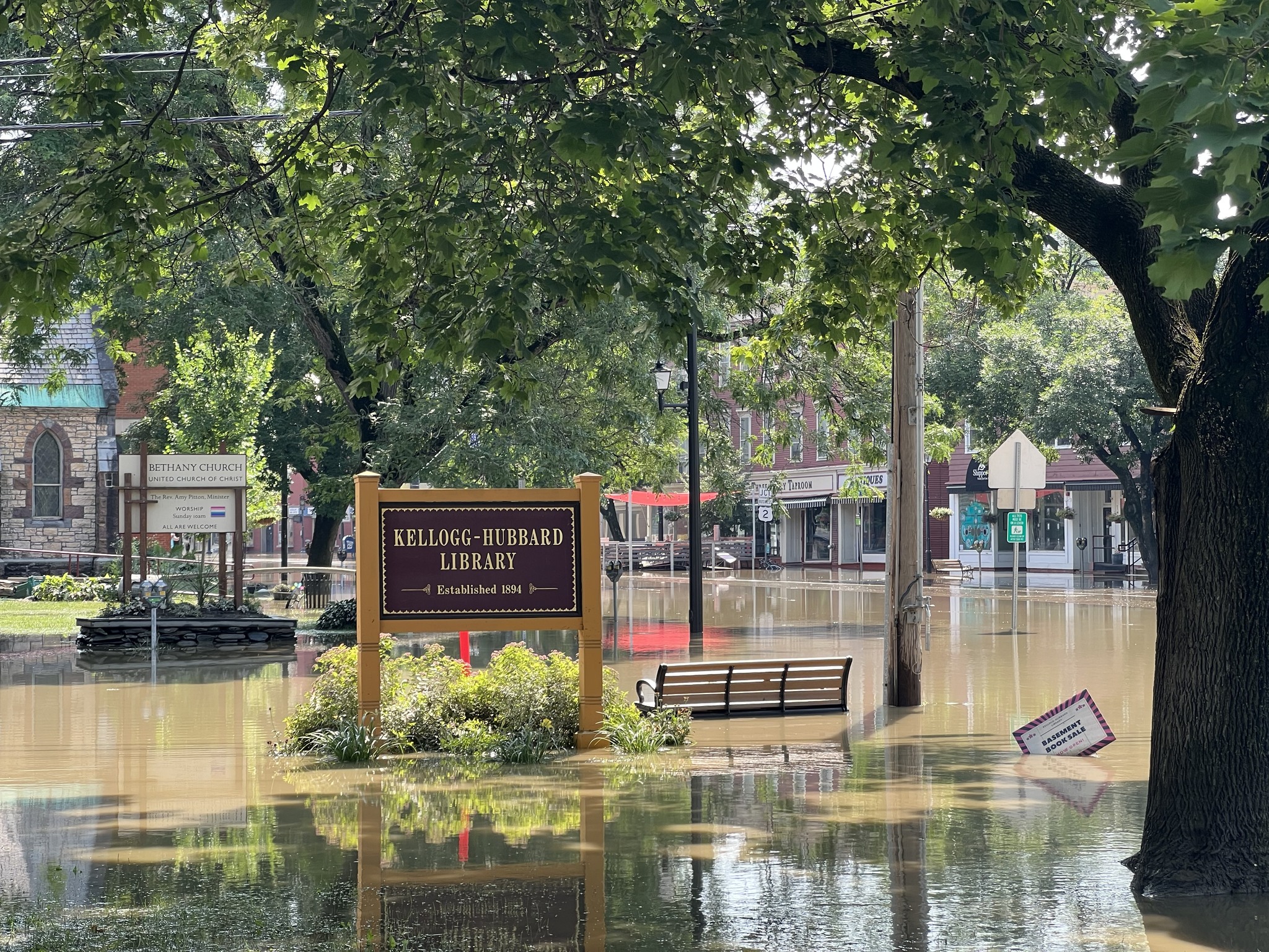 Flooded streets surround the Kellogg-Hubbard Library sign