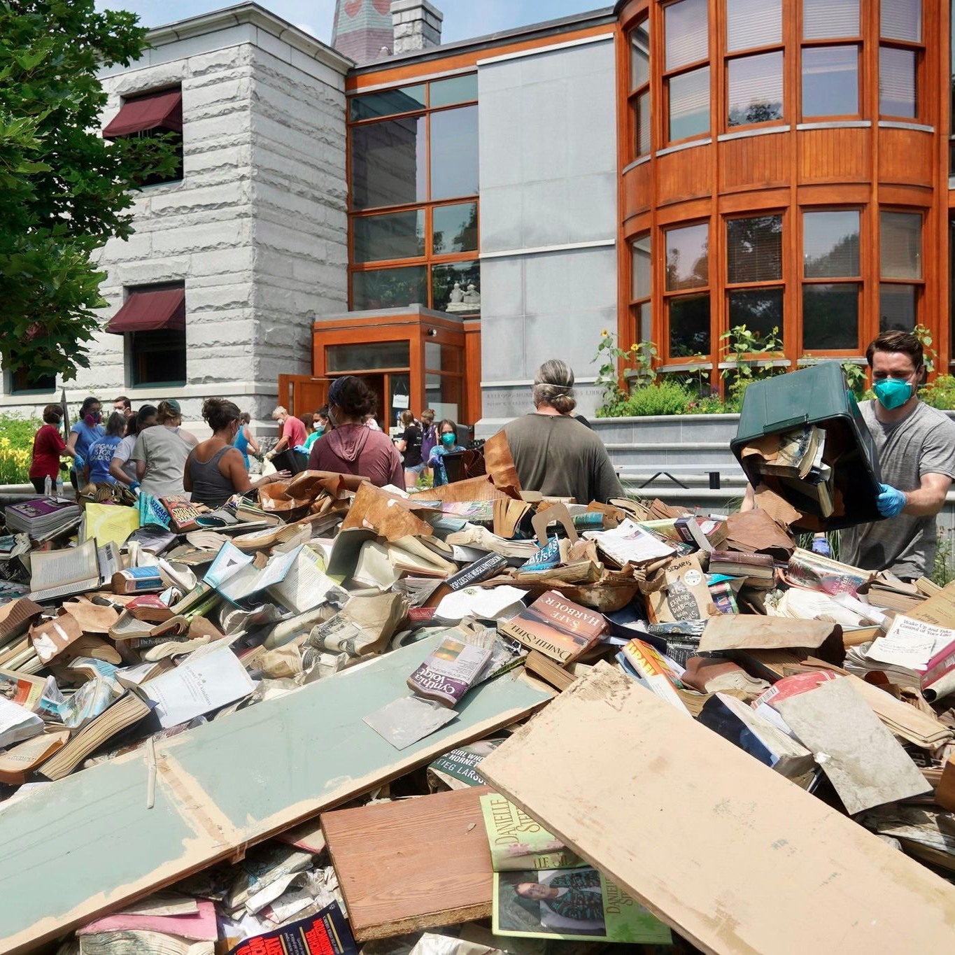 Pile of destroyed books and debris outside of School Street entrance of library.