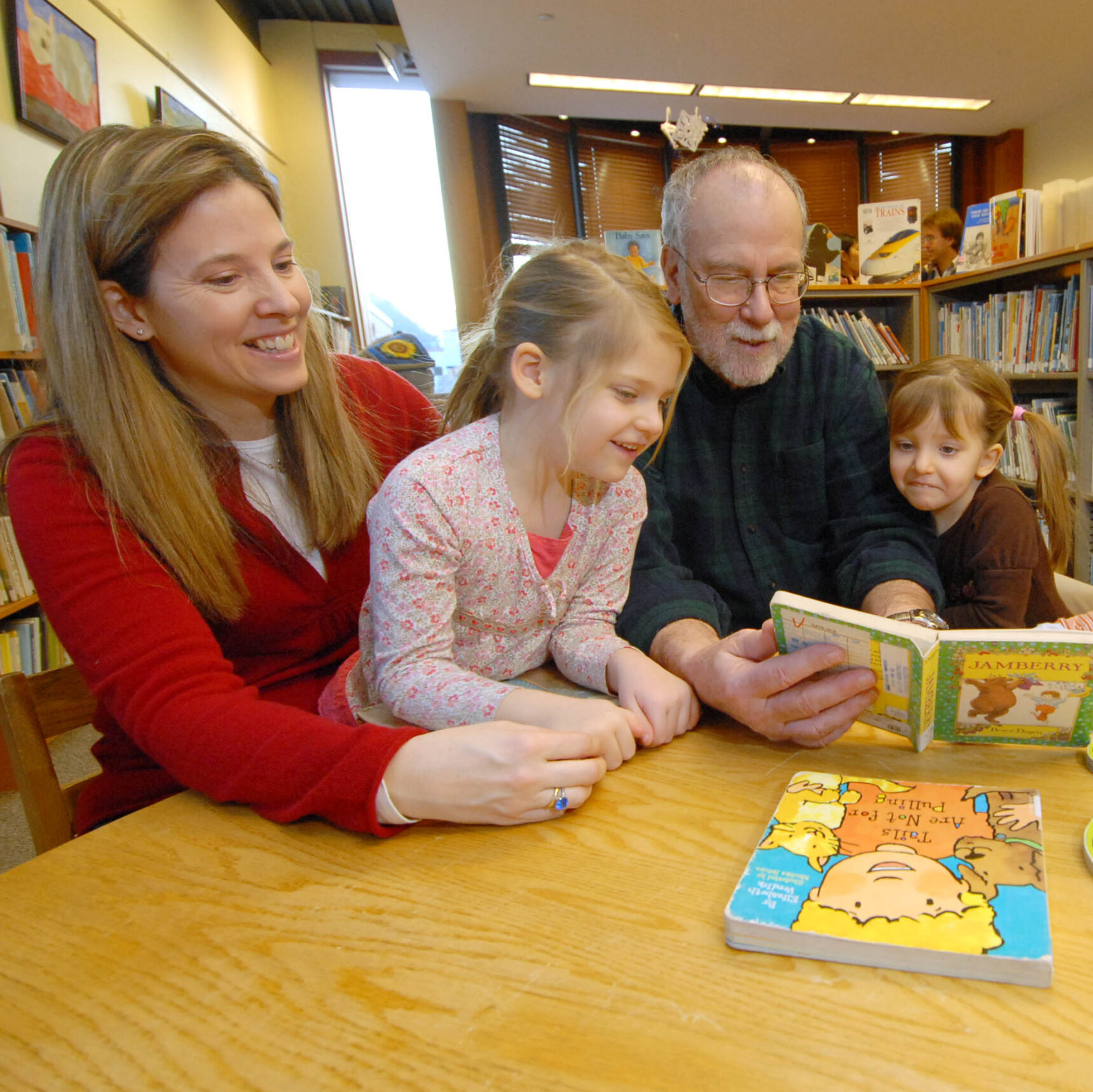 Multi-generational family reading a story together
