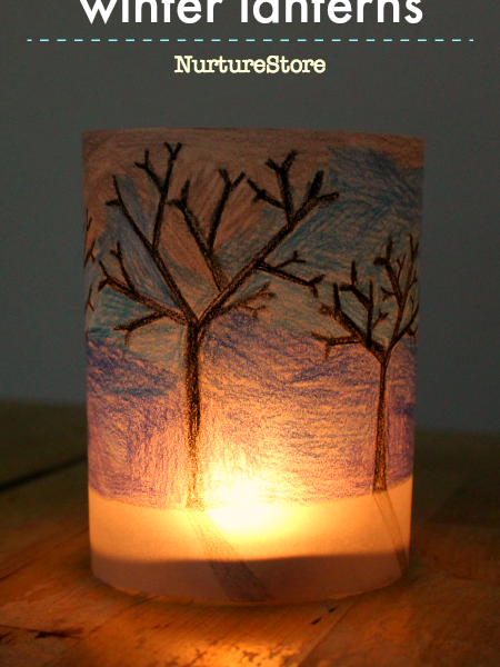 Image of a glowing handmade paper lantern with trees drawn on it.