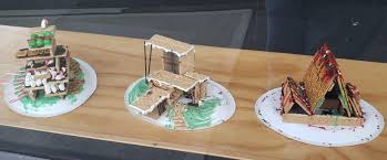 Image of three houses made from graham crackers and icing.