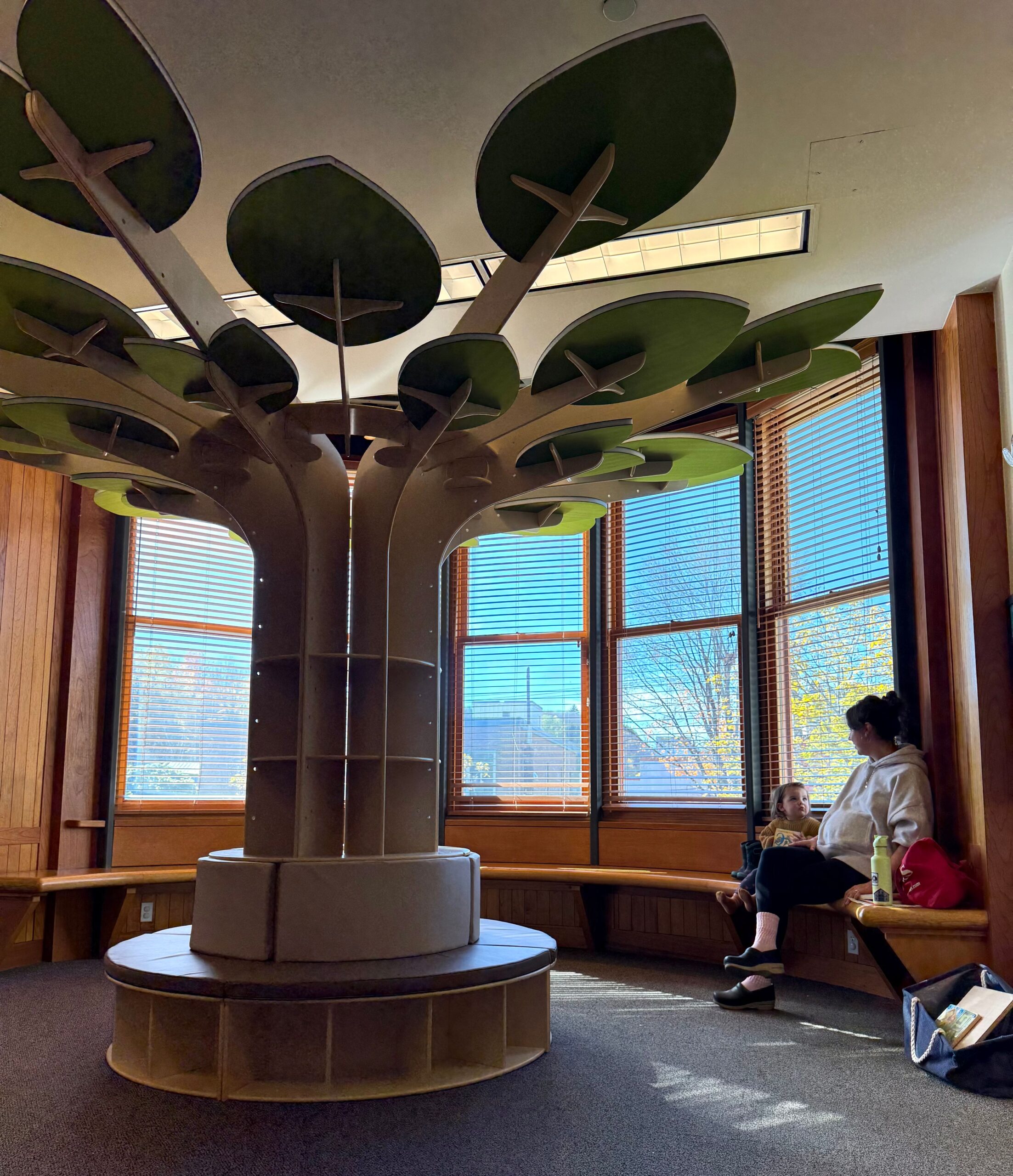 Pictured: Elaine and Maeve enjoy the latest addition to the Children's Library, our brand-new reading tree.