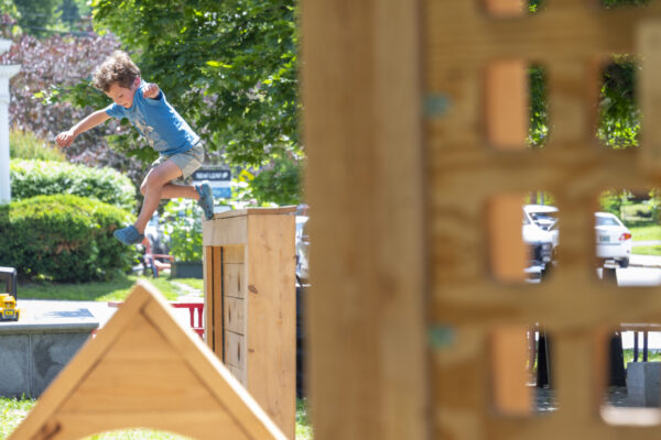 Boy leaps on playscape