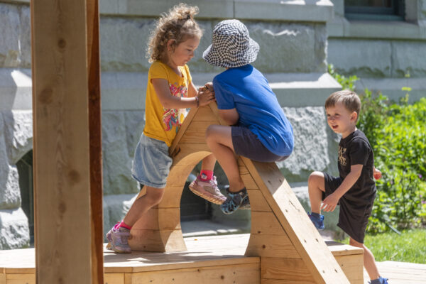 Two kids play on playscape