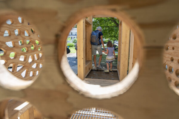 A woman and a child enjoy the playstructure.