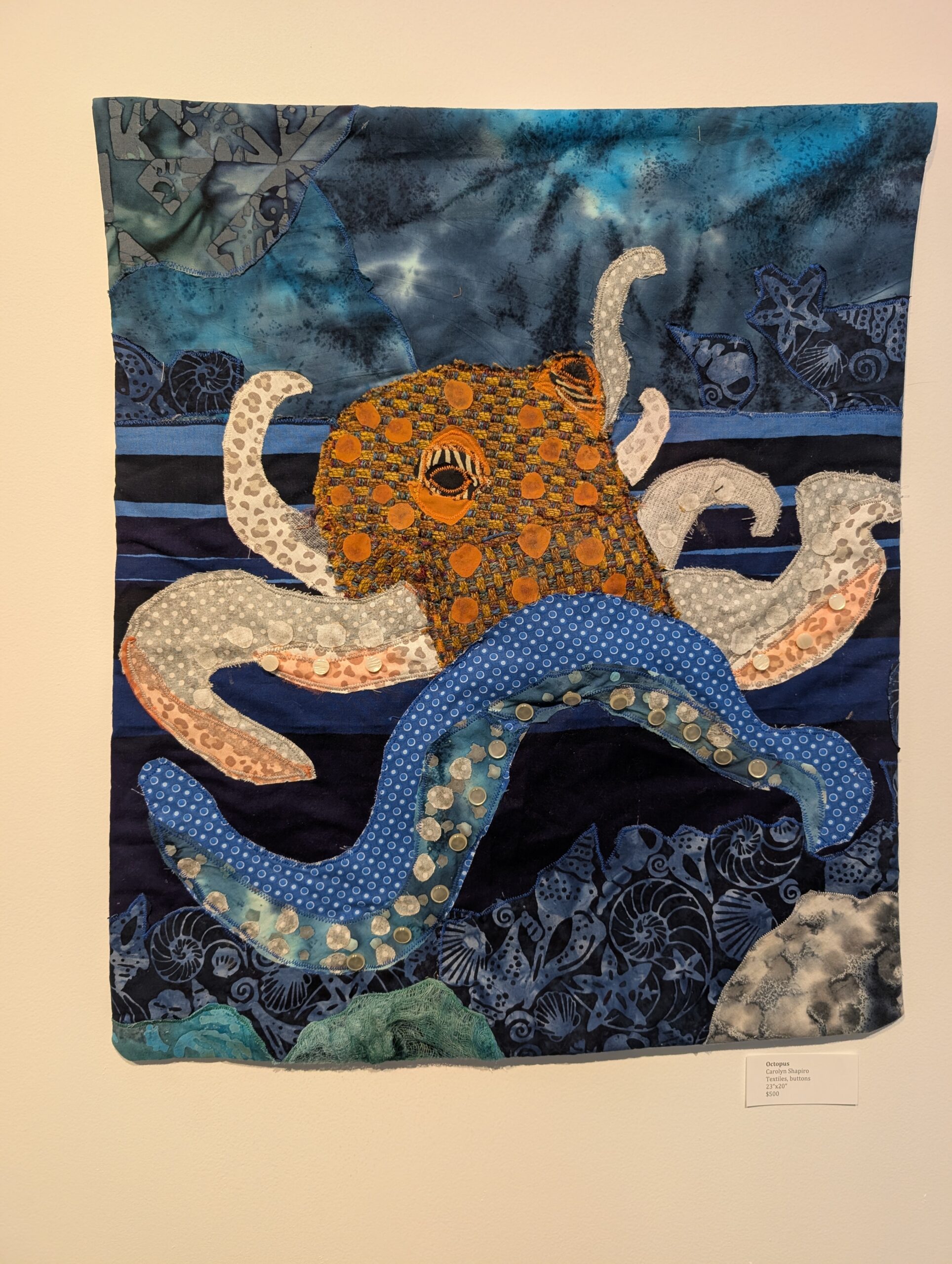 Octopus image sewn on fabric.